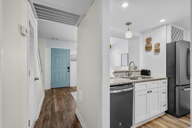 5508 Porcher Dr Unit 3, Myrtle Beach, SC 29577 - kitchen featuring freestanding refrigerator, dishwasher, a sink, light stone counters, and white cabinets