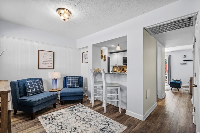 5508 Porcher Dr Unit 3, Myrtle Beach, SC 29577 - living area featuring wood finished floors, baseboards, and a textured ceiling
