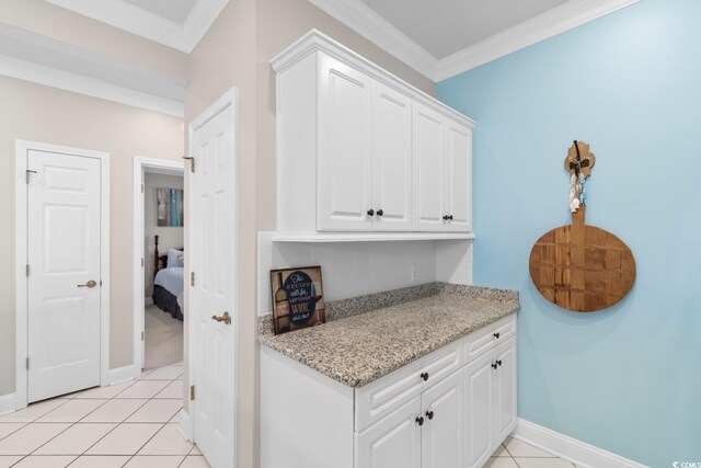 4400 Turtle Ln Unit 3-A, Little River, SC 29566 - kitchen featuring baseboards, white cabinetry, ornamental molding, and light tile patterned flooring