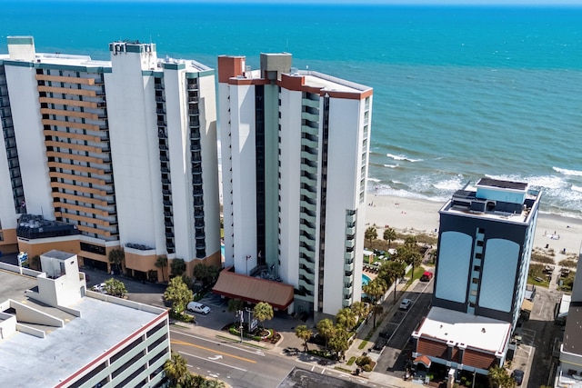 drone / aerial view featuring a beach view and a water view