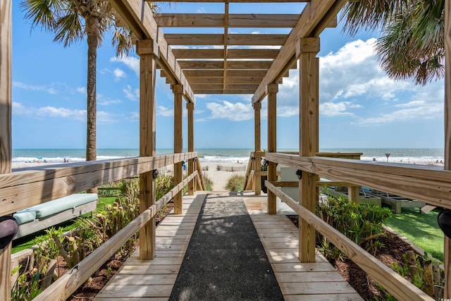 view of property's community featuring a beach view and a water view