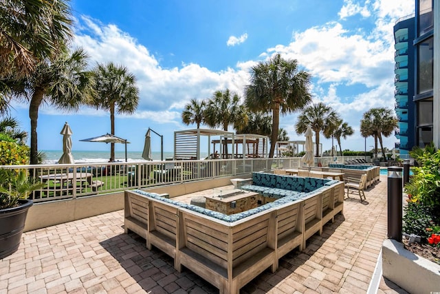 view of patio / terrace featuring a pool and a water view