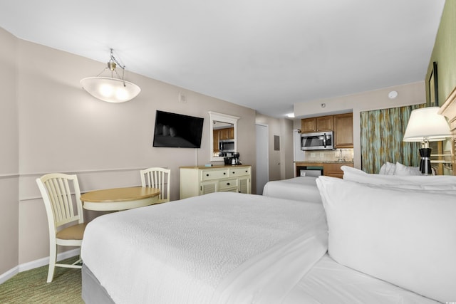 bedroom featuring light colored carpet and baseboards