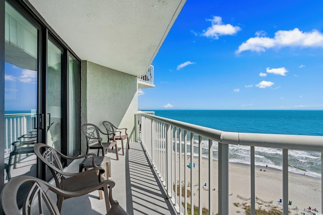 balcony featuring a beach view and a water view