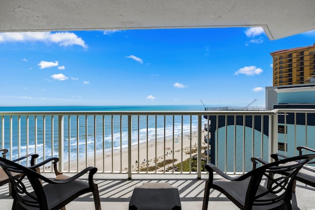 balcony featuring a beach view and a water view