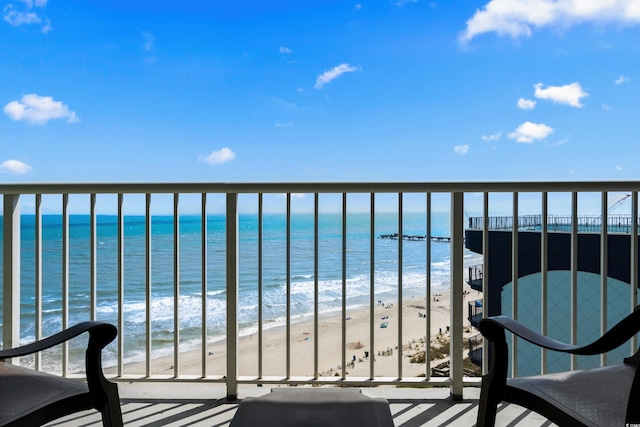 balcony with a view of the beach and a water view