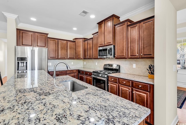 522 Heartland Ct, Murrells Inlet, SC 29576 - kitchen featuring appliances with stainless steel finishes, crown molding, light stone countertops, decorative backsplash, and a sink