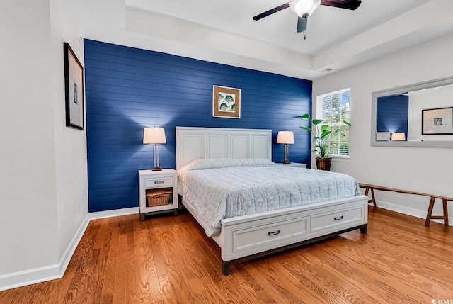 522 Heartland Ct, Murrells Inlet, SC 29576 - bedroom with baseboards, visible vents, an accent wall, ceiling fan, and wood finished floors
