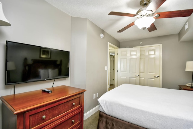 bedroom featuring visible vents, dark colored carpet, and baseboards