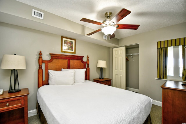 bedroom with visible vents, baseboards, a closet, and a textured ceiling
