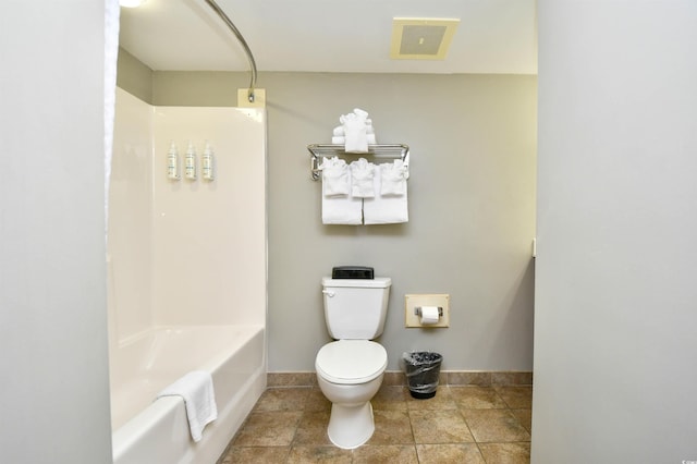 bathroom with visible vents, toilet, washtub / shower combination, tile patterned floors, and baseboards