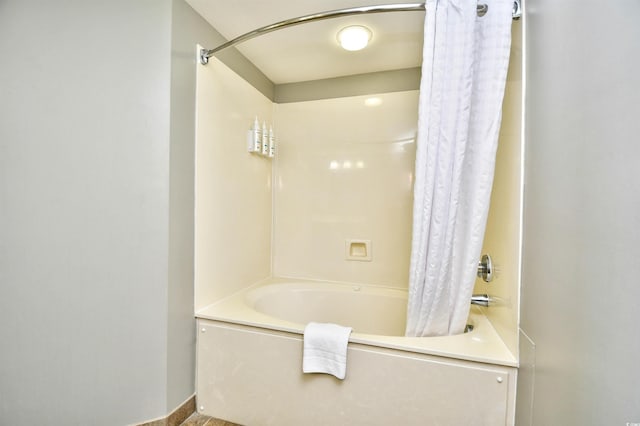 full bathroom featuring baseboards and shower / bathtub combination with curtain