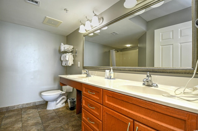 bathroom with toilet, curtained shower, a sink, and visible vents
