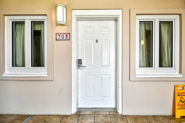 entrance to property with stucco siding