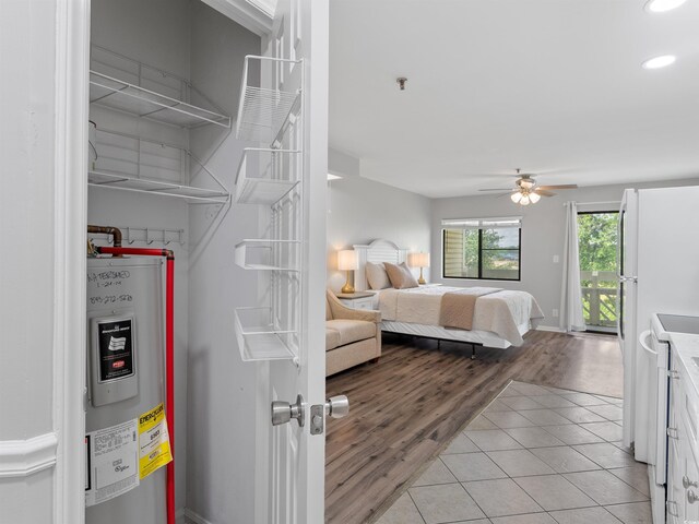 1100 Possum Trot Rd Unit G-216, North Myrtle Beach, SC 29582 - bedroom featuring electric water heater, access to exterior, light tile patterned flooring, recessed lighting, and a ceiling fan