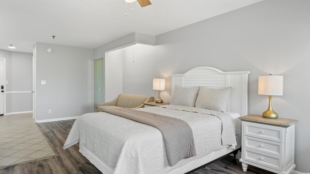1100 Possum Trot Rd Unit G-216, North Myrtle Beach, SC 29582 - bedroom with wood finished floors, baseboards, and ceiling fan