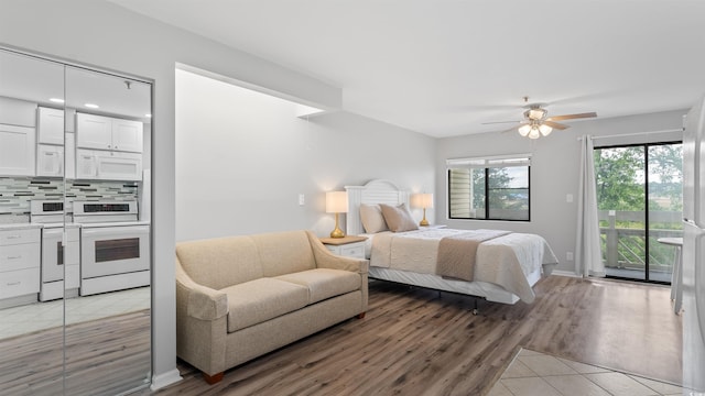 1100 Possum Trot Rd Unit G-216, North Myrtle Beach, SC 29582 - bedroom with access to exterior, light wood finished floors, ceiling fan, and washer / dryer