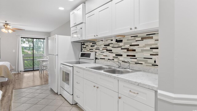 1100 Possum Trot Rd Unit G-216, North Myrtle Beach, SC 29582 - kitchen featuring white appliances, a sink, ceiling fan, backsplash, and white cabinets