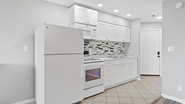 1100 Possum Trot Rd Unit G-216, North Myrtle Beach, SC 29582 - kitchen with white appliances, backsplash, light countertops, white cabinetry, and recessed lighting