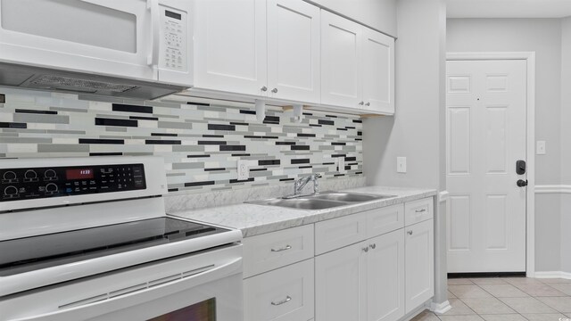 1100 Possum Trot Rd Unit G-216, North Myrtle Beach, SC 29582 - kitchen featuring white appliances, a sink, light countertops, backsplash, and white cabinets