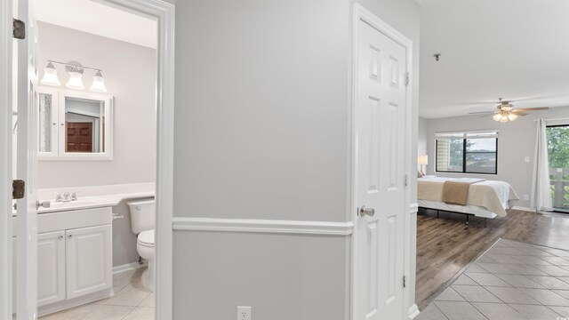 1100 Possum Trot Rd Unit G-216, North Myrtle Beach, SC 29582 - bathroom with vanity, toilet, tile patterned floors, a ceiling fan, and baseboards