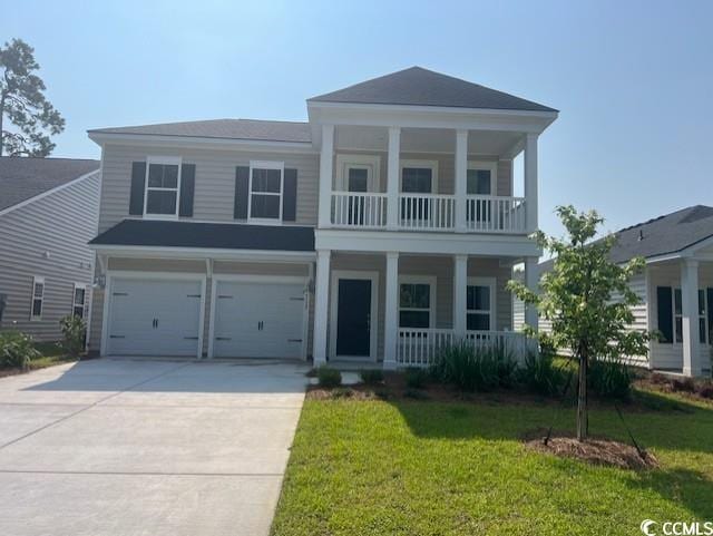 9738 Indigo Creek Blvd, Murrells Inlet, SC 29576 - neoclassical home featuring covered porch, a balcony, concrete driveway, an attached garage, and a front lawn