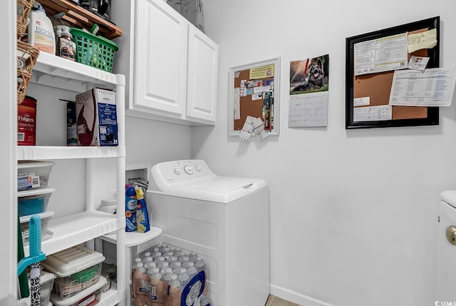 clothes washing area featuring cabinet space and washer and dryer