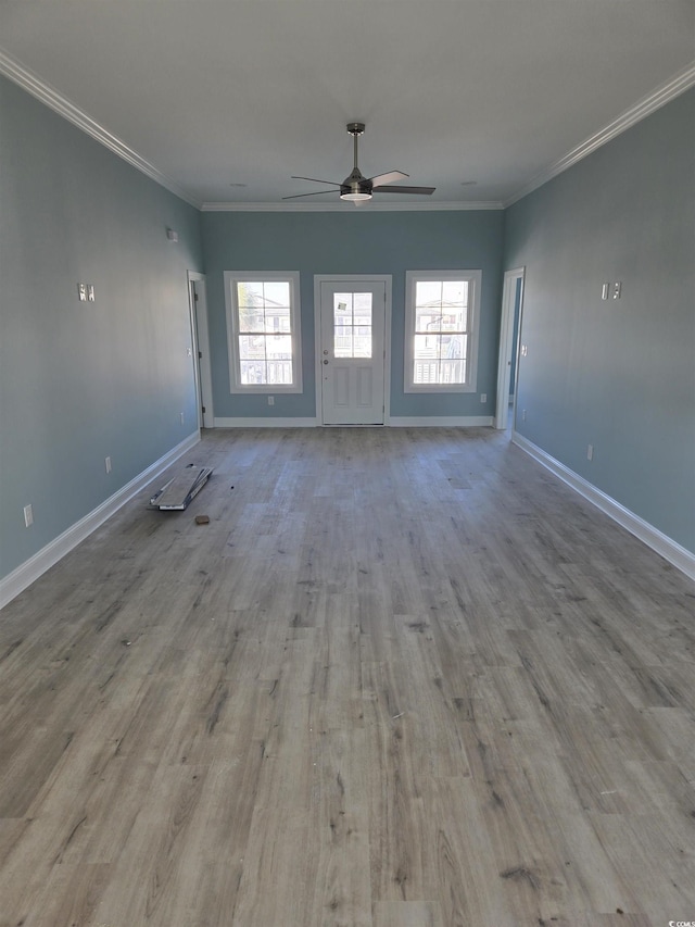 4831 Riverside Dr, North Myrtle Beach, SC 29582 - unfurnished living room featuring a ceiling fan, wood finished floors, baseboards, and crown molding