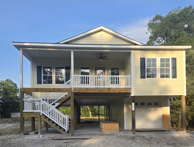 4831 Riverside Dr, North Myrtle Beach, SC 29582 - raised beach house with an attached garage, a ceiling fan, stairway, and covered porch