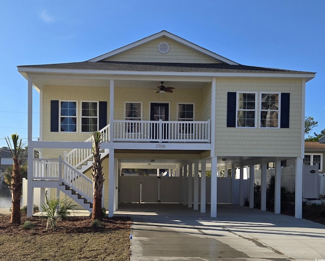 4831 Riverside Dr, North Myrtle Beach, SC 29582 - coastal inspired home with ceiling fan, a carport, stairway, concrete driveway, and covered porch