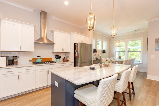 402 Bumble Cir, Murrells Inlet, SC 29576 - kitchen featuring a chandelier, appliances with stainless steel finishes, light wood finished floors, and wall chimney exhaust hood