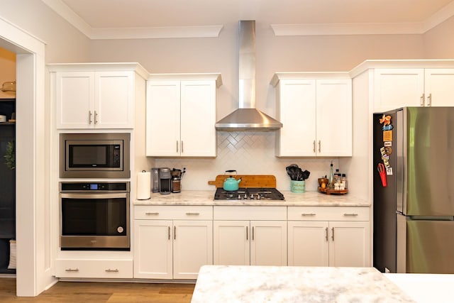 402 Bumble Cir, Murrells Inlet, SC 29576 - kitchen with crown molding, appliances with stainless steel finishes, light wood-style floors, wall chimney exhaust hood, and decorative backsplash