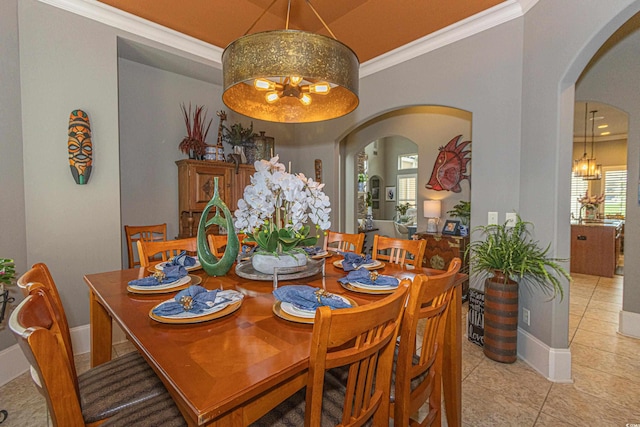 5208 Nightingale Dr, Myrtle Beach, SC 29577 - dining area featuring a chandelier, arched walkways, light tile patterned floors, ornamental molding, and baseboards