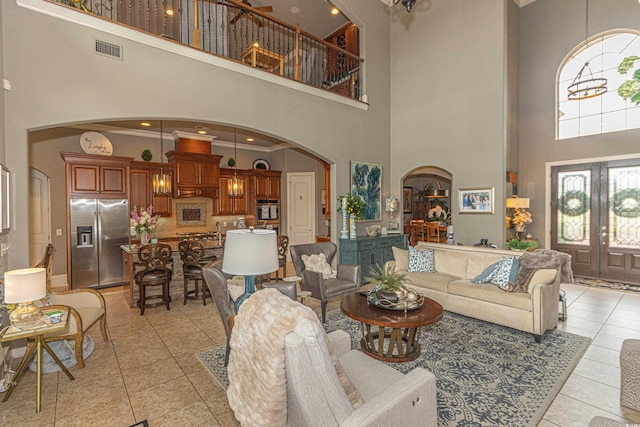 5208 Nightingale Dr, Myrtle Beach, SC 29577 - living area featuring arched walkways, a high ceiling, light tile patterned flooring, and french doors