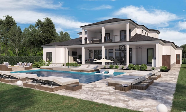 rear view of property featuring outdoor lounge area, a patio area, a ceiling fan, and a balcony