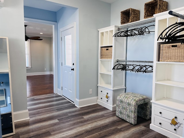 mudroom featuring baseboards and dark wood-type flooring