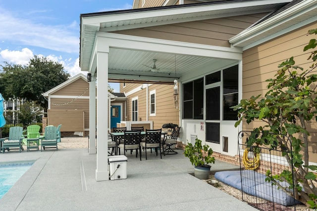 view of patio with fence, outdoor dining area, and an outdoor pool