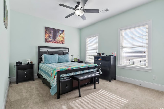 bedroom with visible vents, ceiling fan, carpet flooring, and baseboards