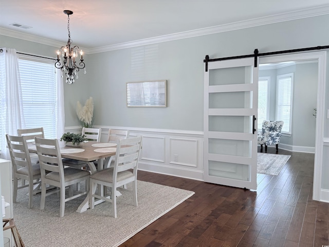 712 Crystal Water Way, Myrtle Beach, SC 29579 - dining room featuring plenty of natural light, a chandelier, dark wood finished floors, ornamental molding, and a barn door
