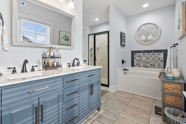 full bathroom featuring a bath, a shower stall, double vanity, and a sink