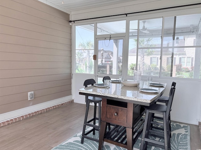712 Crystal Water Way, Myrtle Beach, SC 29579 - dining area featuring wood walls, wood finished floors, and a sunroom