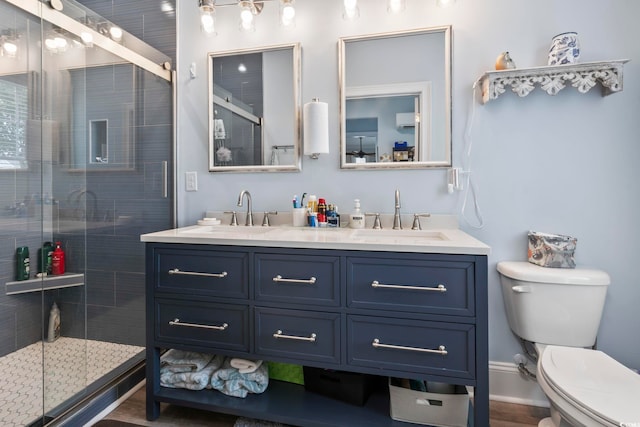 full bath with a stall shower, toilet, and a sink