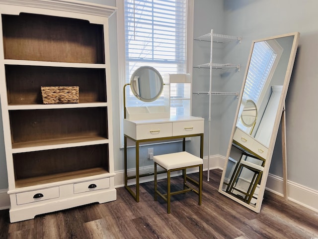 interior space with baseboards and dark wood-style flooring