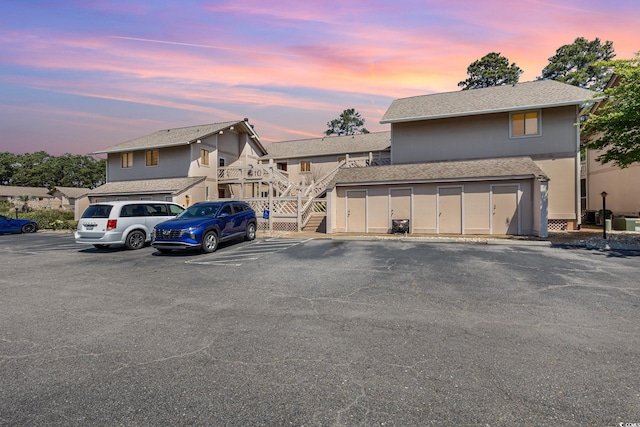 3015 Old Bryan Dr Unit 10-7, Myrtle Beach, SC 29577 - view of front of house with roof with shingles, stairway, and uncovered parking