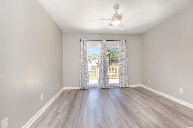 3015 Old Bryan Dr Unit 10-7, Myrtle Beach, SC 29577 - empty room featuring a textured ceiling, baseboards, a ceiling fan, and wood finished floors