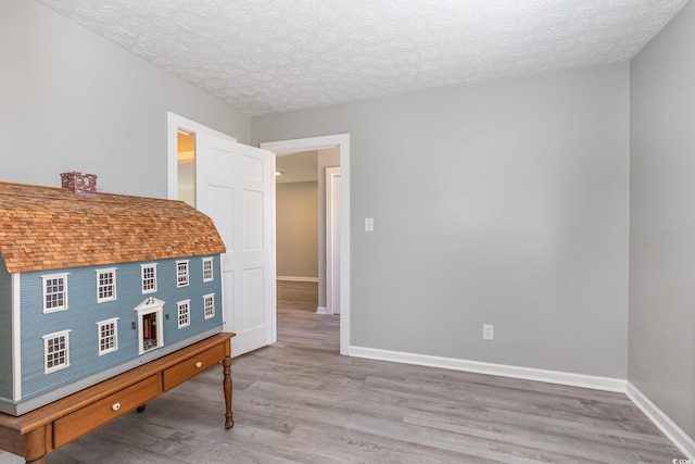 3015 Old Bryan Dr Unit 10-7, Myrtle Beach, SC 29577 - bedroom featuring baseboards, wood finished floors, and a textured ceiling
