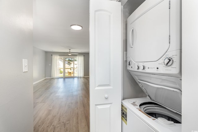3015 Old Bryan Dr Unit 10-7, Myrtle Beach, SC 29577 - laundry area featuring baseboards, a ceiling fan, stacked washing maching and dryer, light wood-style floors, and laundry area
