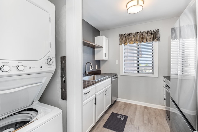 3015 Old Bryan Dr Unit 10-7, Myrtle Beach, SC 29577 - laundry room with light wood finished floors, stacked washer / dryer, baseboards, and a sink