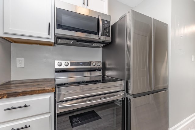 3015 Old Bryan Dr Unit 10-7, Myrtle Beach, SC 29577 - kitchen with stainless steel appliances, white cabinets, and wooden counters