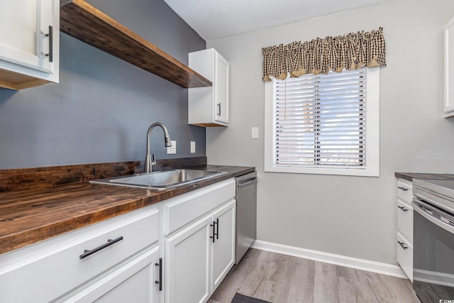 3015 Old Bryan Dr Unit 10-7, Myrtle Beach, SC 29577 - kitchen featuring white cabinetry, butcher block counters, stainless steel appliances, light wood finished floors, and a sink